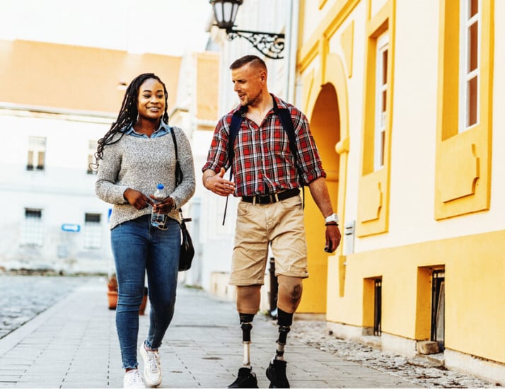 man and a woman walking down the street while traveling