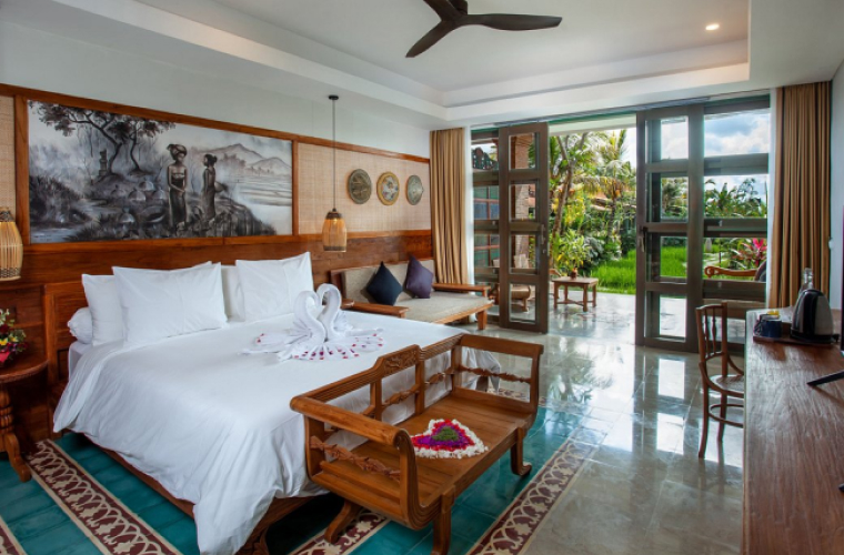 Beautiful hotel room opening onto a tropical lawn at the Hotel Arya Arkananta.